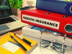 Red Office Folder with Inscription Health Insurance on Office Desktop with Office Supplies and Modern Laptop. Business Concept on Blurred Background. Toned Image.-2